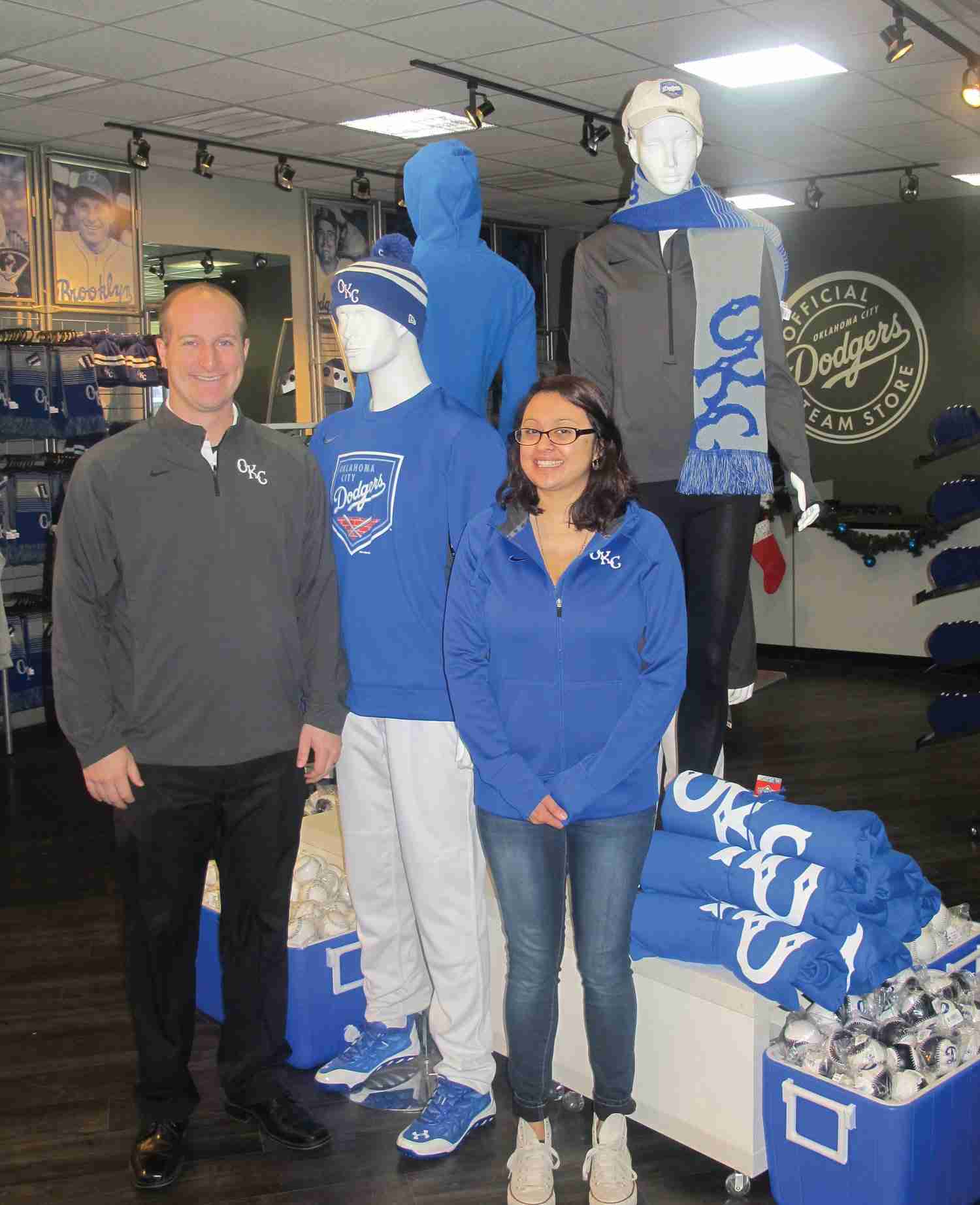 Mitch Stubenhofer, director of operations, and Otilia Mares, retail operations manager, the Oklahoma City Dodgers fan store in Oklahoma City, Okla. Hats are number one in apparel sales for the shop.