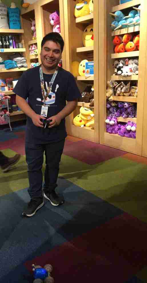 Robert Ontiveros, guest service representative, Chicago Children’s Museum. The store makes use of feature tables to highlight new items.