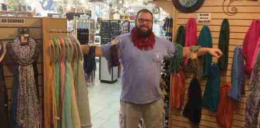 Matt Palmer photographed with scarves at Sunset Beach Gifts. The owner said placing scarves, glasses and other fashion accessories near clothing helps spur sales.